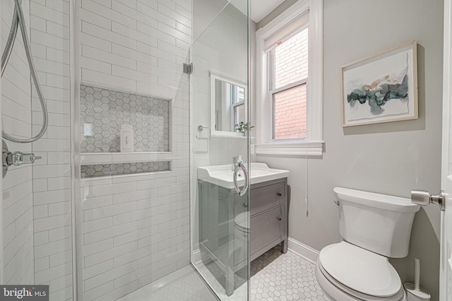 1823 4th St NW, Washington, DC 20001 - bathroom featuring toilet, vanity, tiled shower, tile patterned floors, and baseboards