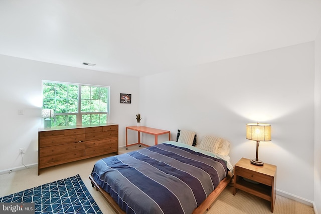 carpeted bedroom featuring baseboards