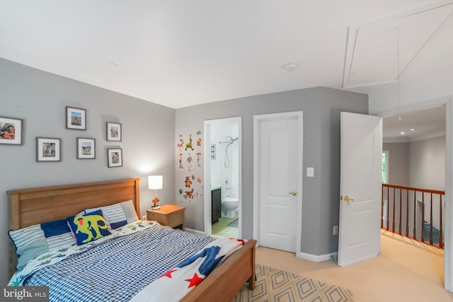 bedroom featuring attic access, light carpet, baseboards, and ensuite bathroom