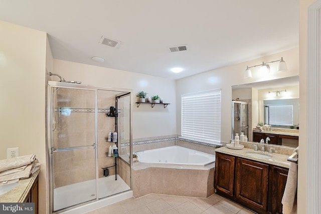 bathroom featuring a shower stall, a garden tub, tile patterned floors, and vanity