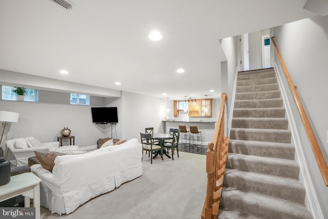 living room with recessed lighting, stairway, carpet floors, and bar