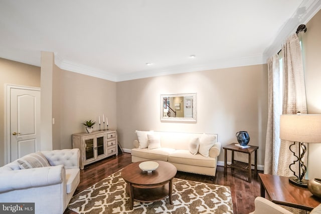 living room featuring wood finished floors, ornamental molding, and baseboards