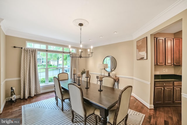 dining area featuring a chandelier, dark wood-type flooring, ornamental molding, and baseboards