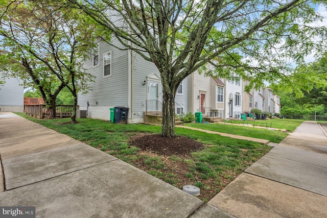 view of home's exterior with a lawn, a residential view, and central air condition unit