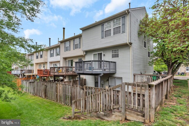 back of house with a deck