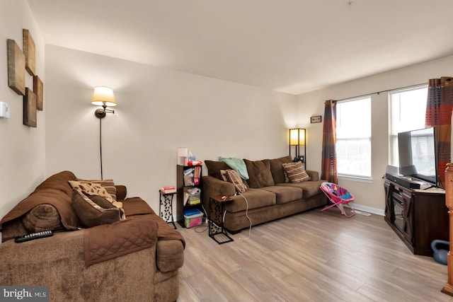 living room featuring light wood-type flooring and baseboards