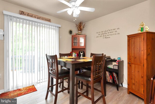 dining space with light wood-style flooring and ceiling fan