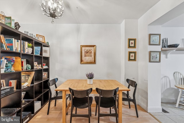 2429 S Reese St, Philadelphia, PA 19148 - dining room with a chandelier, baseboards, and wood finished floors