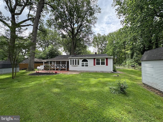 rear view of house featuring an outbuilding, a storage shed, and crawl space