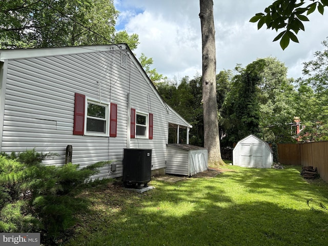 view of property exterior featuring a storage unit, central air condition unit, and an outbuilding