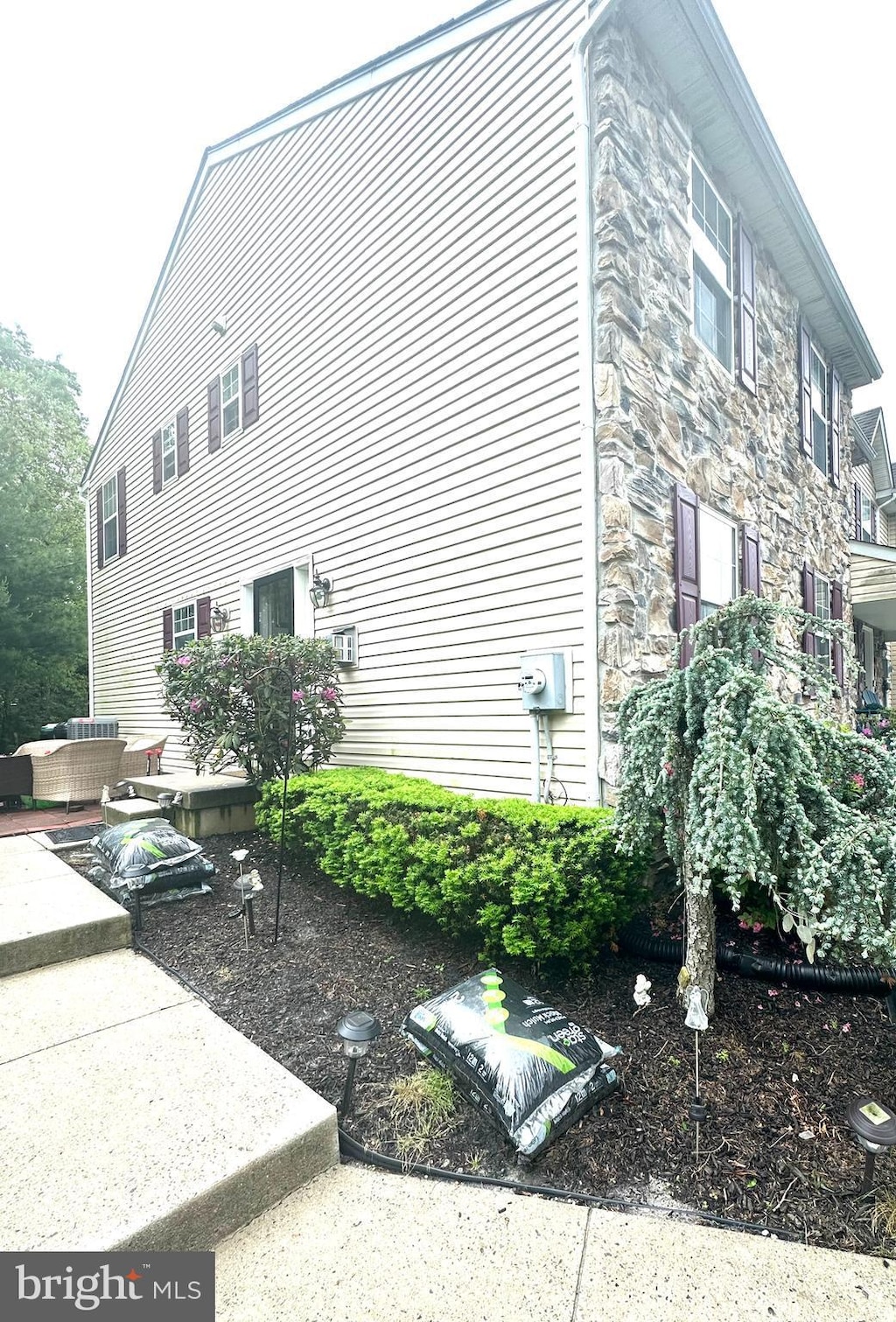 39 Normans Ford Dr, Sicklerville, NJ 08081 - view of side of home featuring stone siding and an outdoor hangout area
