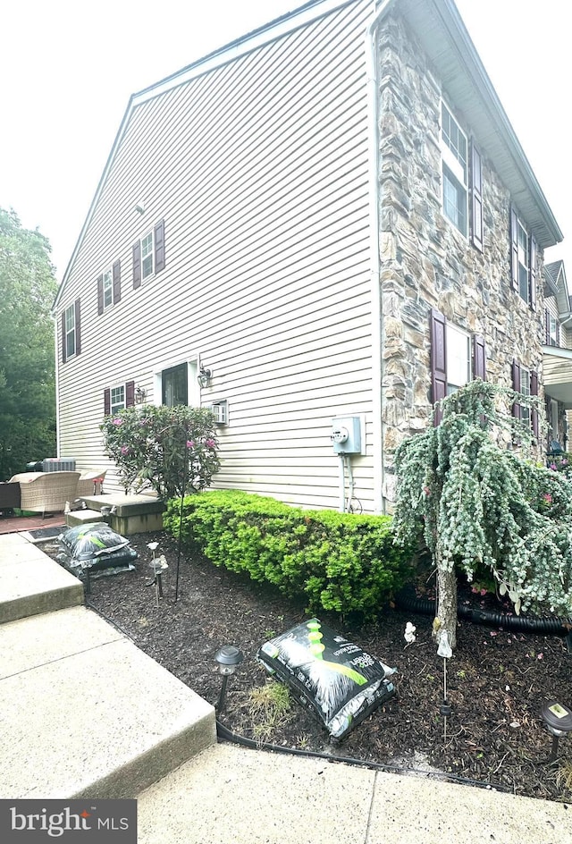 39 Normans Ford Dr, Sicklerville, NJ 08081 - view of side of home featuring stone siding and an outdoor hangout area