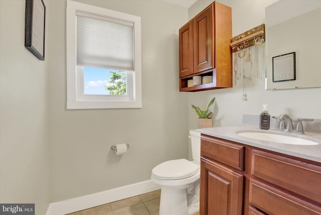 bathroom featuring tile patterned floors, toilet, baseboards, and vanity