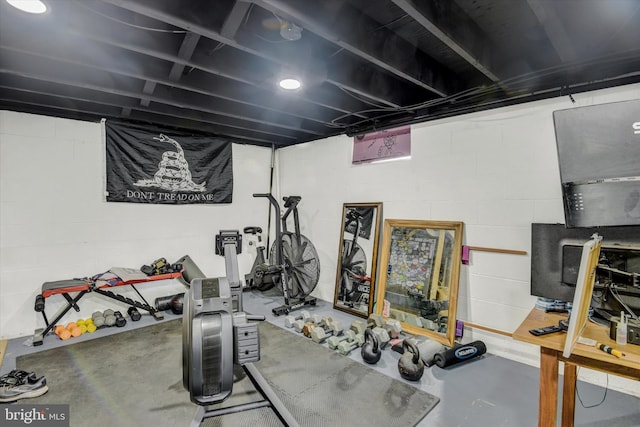 workout area with concrete block wall