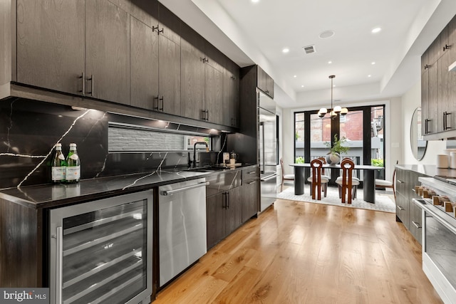 919 French St NW, Washington, DC 20001 - kitchen with premium appliances, beverage cooler, a sink, light wood-type flooring, and a chandelier