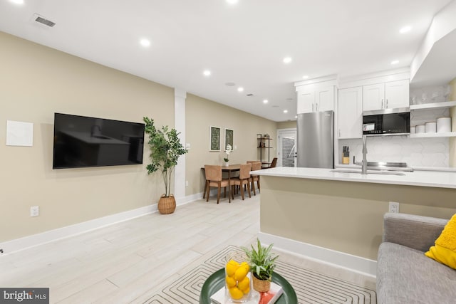 919 French St NW, Washington, DC 20001 - kitchen featuring appliances with stainless steel finishes, open shelves, white cabinetry, recessed lighting, and backsplash