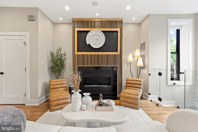 919 French St NW, Washington, DC 20001 - living area with wood finished floors, a glass covered fireplace, baseboards, and recessed lighting