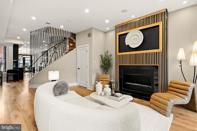 919 French St NW, Washington, DC 20001 - living room featuring stairway, a tile fireplace, wood finished floors, recessed lighting, and baseboards
