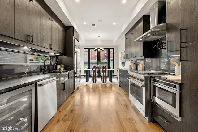 919 French St NW, Washington, DC 20001 - kitchen with stainless steel appliances, beverage cooler, wall chimney exhaust hood, modern cabinets, and dark countertops