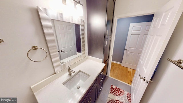306 S Exeter St, Baltimore, MD 21202 - bathroom with vanity, tile patterned flooring, and baseboards