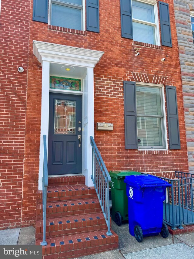 306 S Exeter St, Baltimore, MD 21202 - doorway to property featuring brick siding