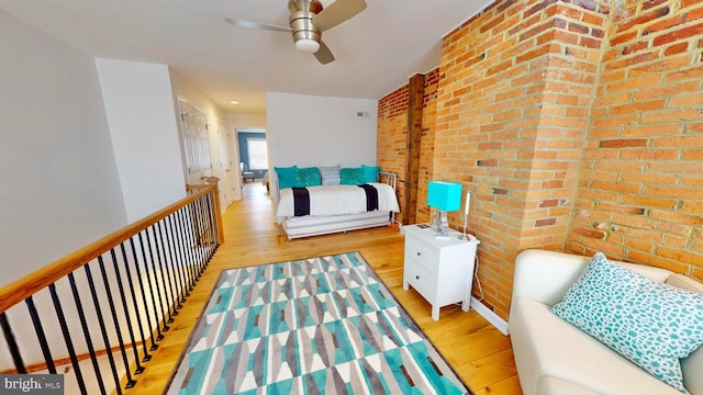 306 S Exeter St, Baltimore, MD 21202 - sitting room featuring wood finished floors, a ceiling fan, and brick wall