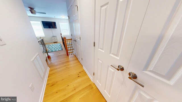 306 S Exeter St, Baltimore, MD 21202 - corridor featuring light wood finished floors and an upstairs landing