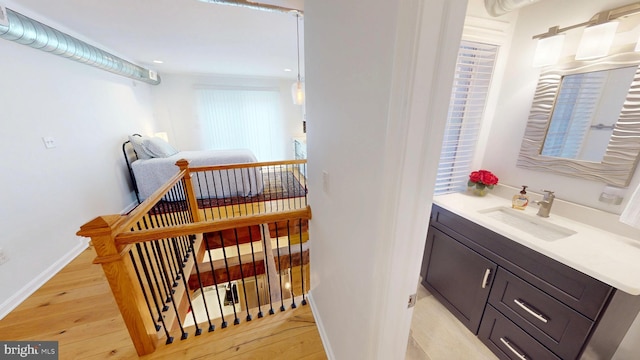 306 S Exeter St, Baltimore, MD 21202 - bathroom featuring hardwood / wood-style flooring, baseboards, vanity, and recessed lighting
