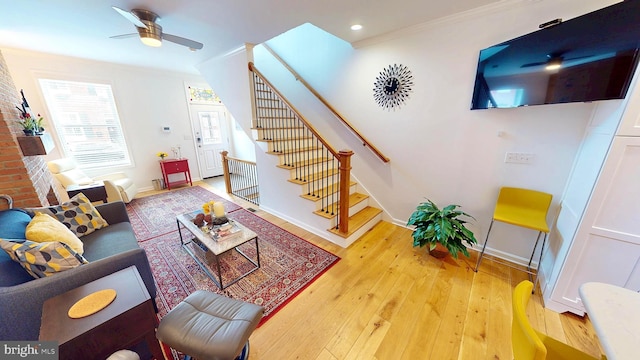 306 S Exeter St, Baltimore, MD 21202 - living area with light wood finished floors, stairs, baseboards, a ceiling fan, and crown molding