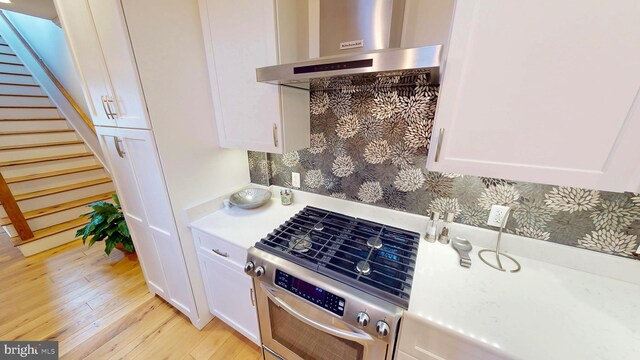 306 S Exeter St, Baltimore, MD 21202 - kitchen featuring exhaust hood, light wood finished floors, white cabinets, and light countertops