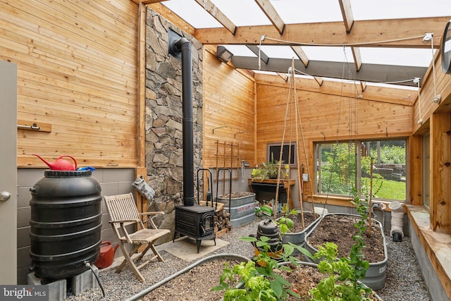 2277 Indian Holw, Winchester, VA 22603 - living area featuring a wood stove, wooden walls, high vaulted ceiling, beamed ceiling, and a skylight