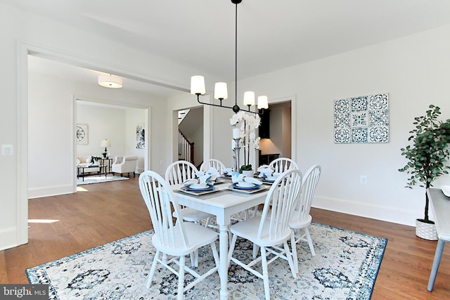 7430 Foundation Way, Springfield, VA 22150 - dining area featuring wood finished floors, stairs, and a chandelier