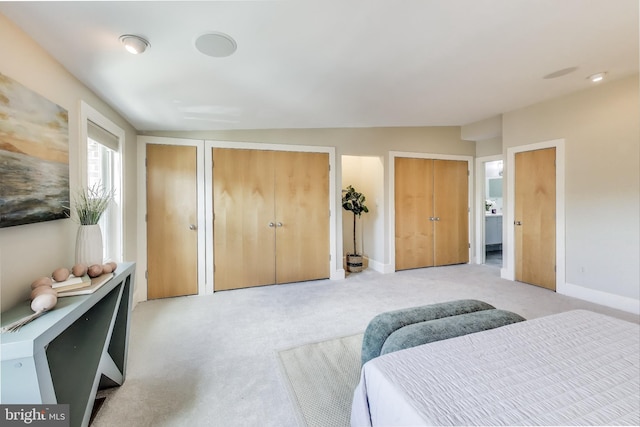 1324 10th St NW, Washington, DC 20001 - bedroom with multiple closets, light carpet, and baseboards