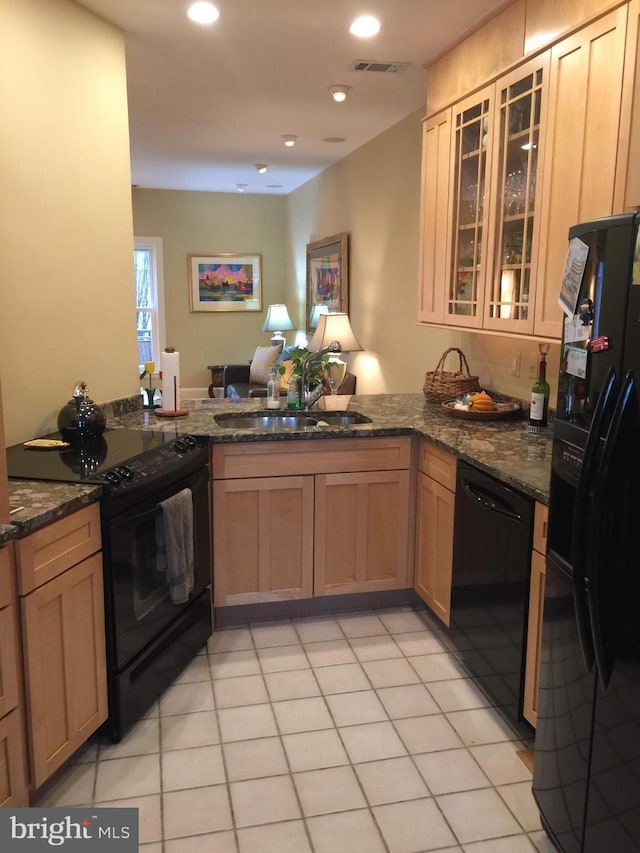 1324 10th St NW, Washington, DC 20001 - kitchen with black appliances, a sink, a peninsula, dark stone countertops, and glass insert cabinets