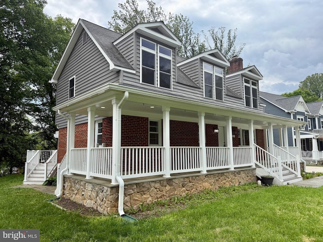view of front of property with a porch, brick siding, a chimney, and roof with shingles
