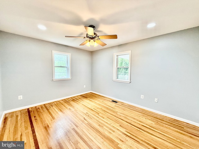spare room with wood finished floors, baseboards, a ceiling fan, and recessed lighting
