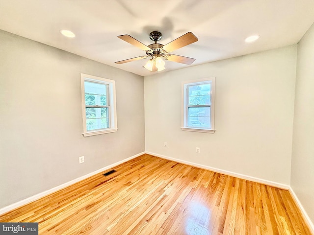 empty room with baseboards, wood finished floors, a ceiling fan, and recessed lighting