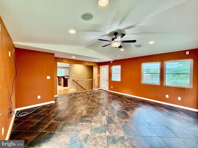 empty room featuring baseboards, a ceiling fan, lofted ceiling, and recessed lighting