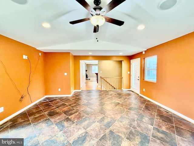 unfurnished room featuring baseboards, ceiling fan, healthy amount of natural light, lofted ceiling, and recessed lighting