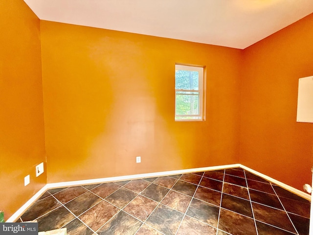 spare room featuring baseboards