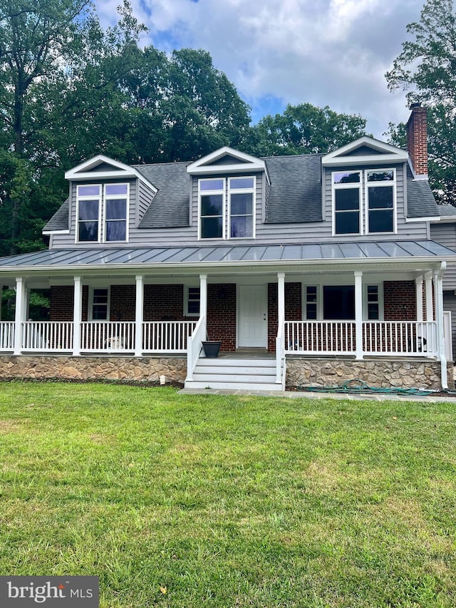 view of front of property with a standing seam roof, covered porch, and metal roof