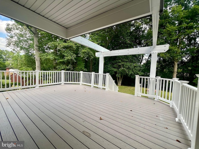wooden deck featuring view of wooded area