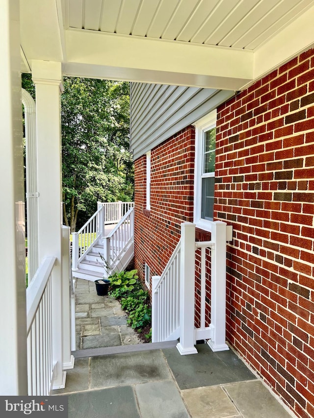 doorway to property featuring brick siding