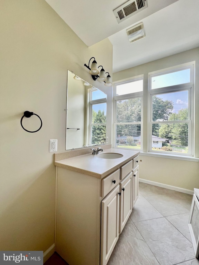 bathroom with vanity and baseboards