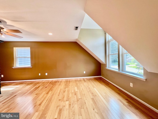 bonus room with a ceiling fan, wood-type flooring, and baseboards