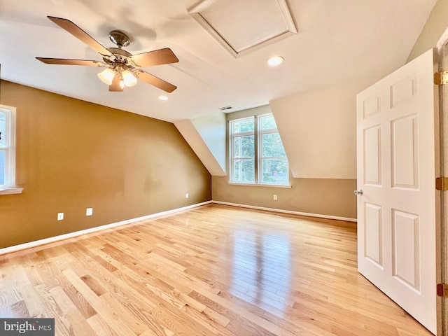 additional living space with light wood-style floors, a ceiling fan, baseboards, lofted ceiling, and recessed lighting