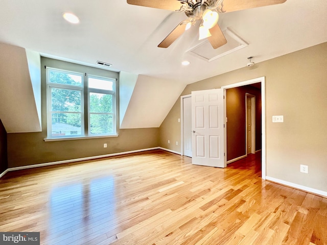 additional living space with wood finished floors, a ceiling fan, baseboards, vaulted ceiling, and recessed lighting