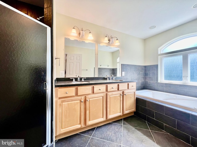 full bath featuring a stall shower, a bath, double vanity, and tile patterned flooring