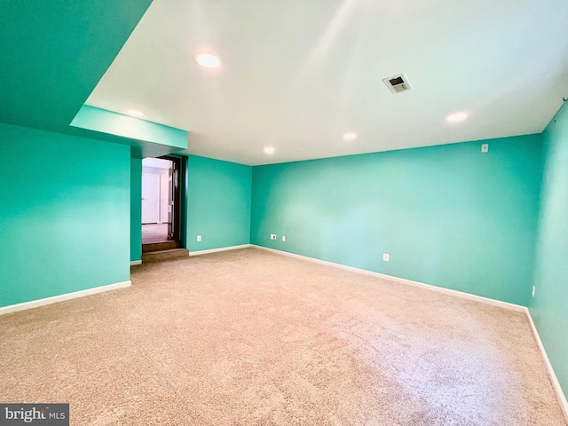 empty room with carpet, baseboards, and recessed lighting