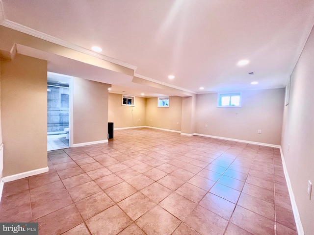 below grade area with recessed lighting, crown molding, light tile patterned flooring, and baseboards